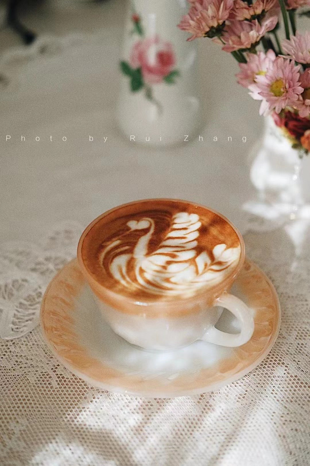 Vintage cup with latte art and flowers